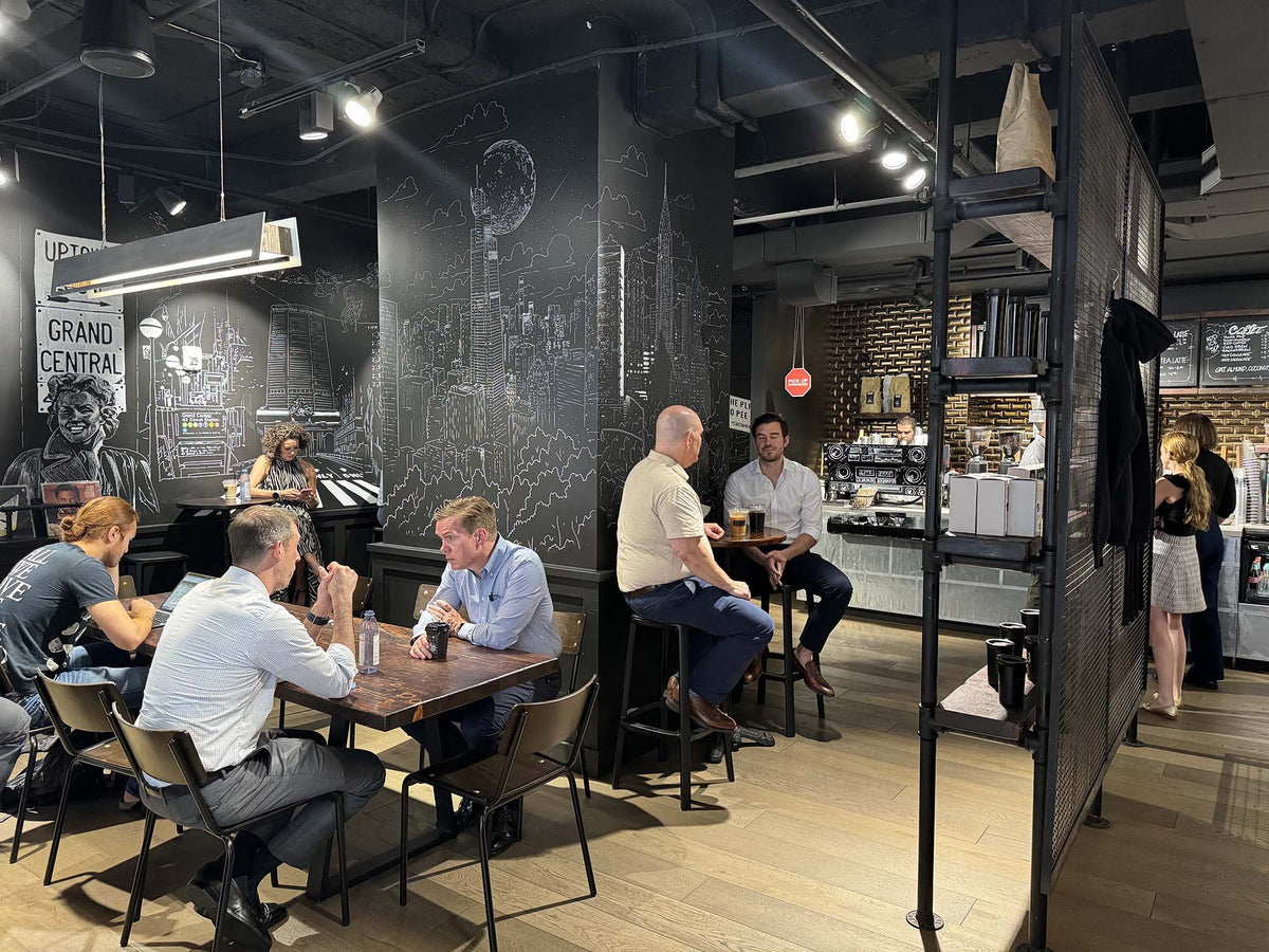Customers working at tables in the seating area at GC Grand Central Station