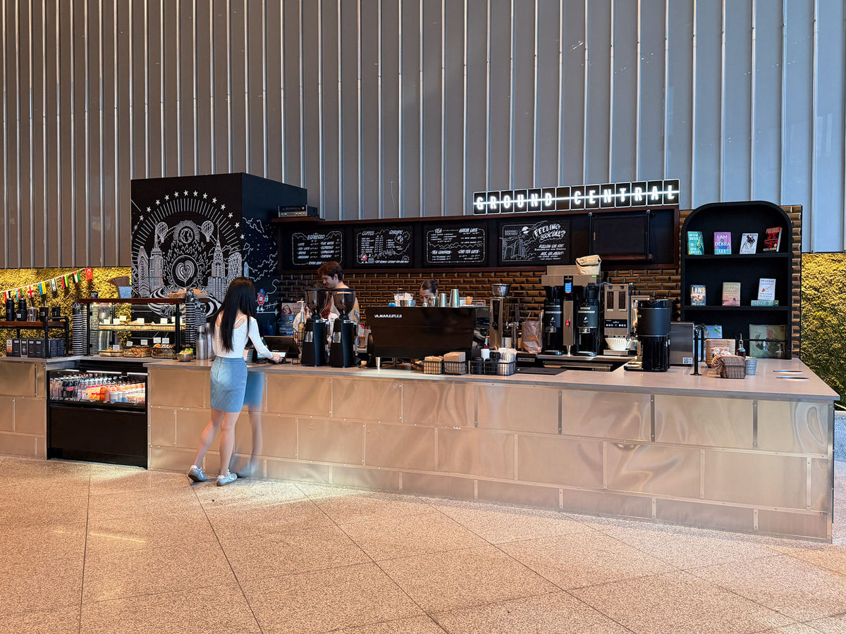 A customer ordering at the GC Park Avenue Plaza kiosk counter in the plaza