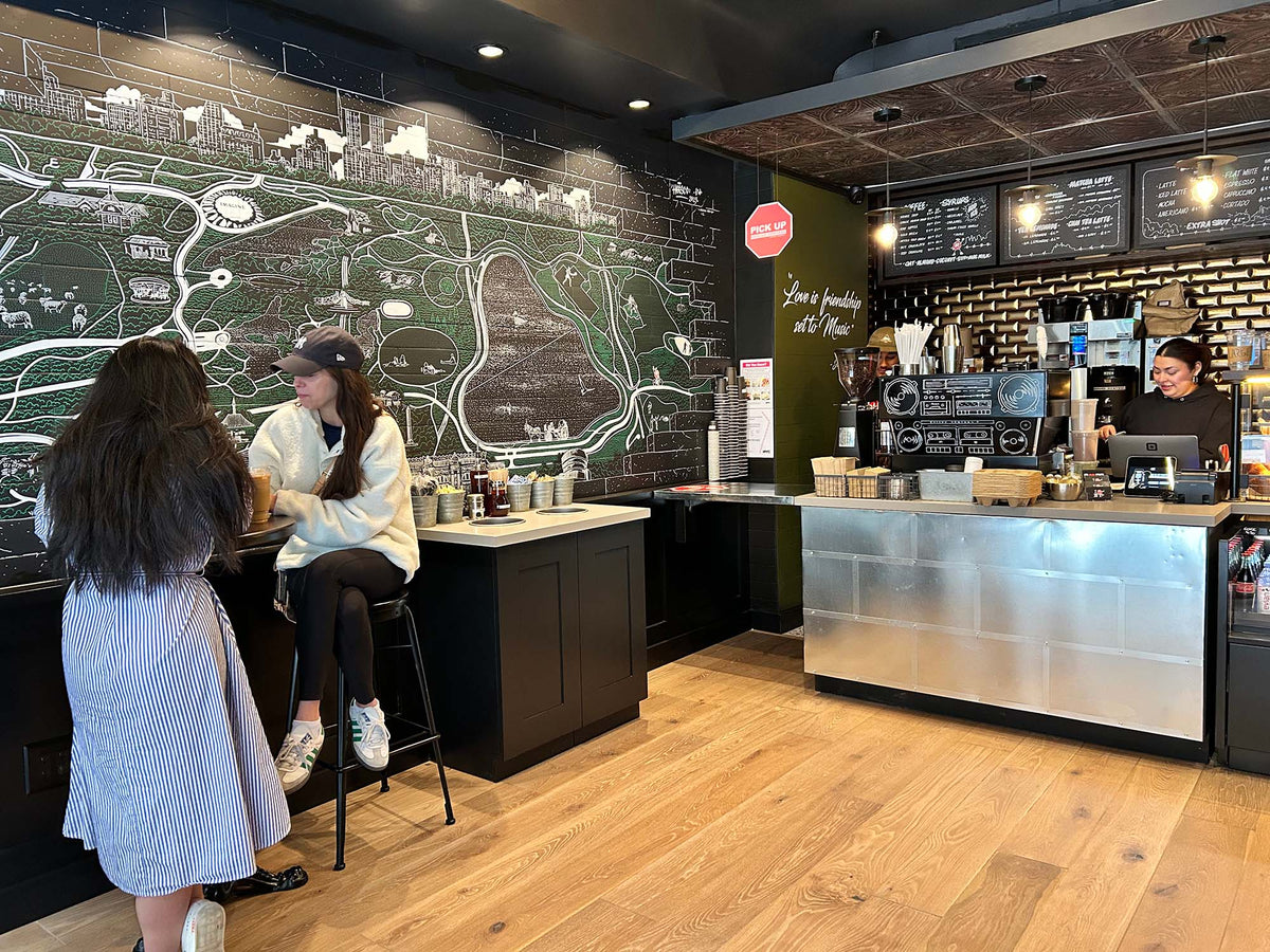 Customers at the counter beside the painted map wall at GC Turtle Bay