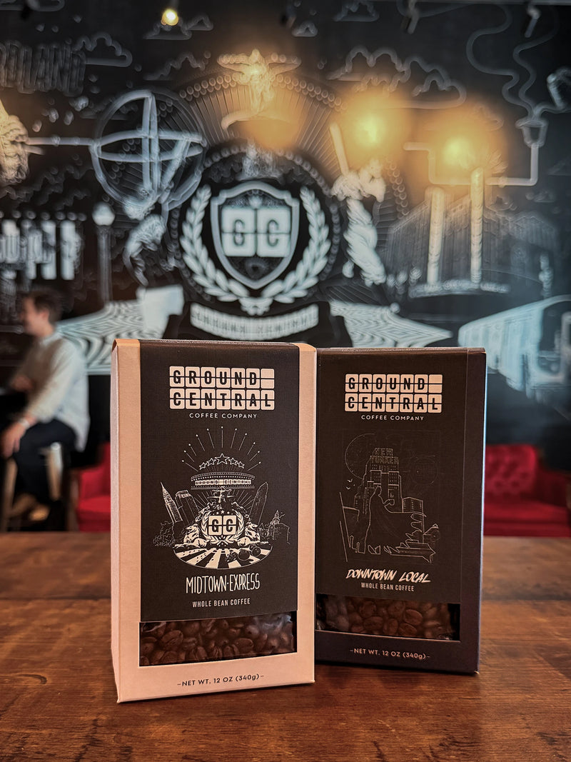 Midtown Express and Downtown Local coffee bags in front of the Ground Central crest mural
